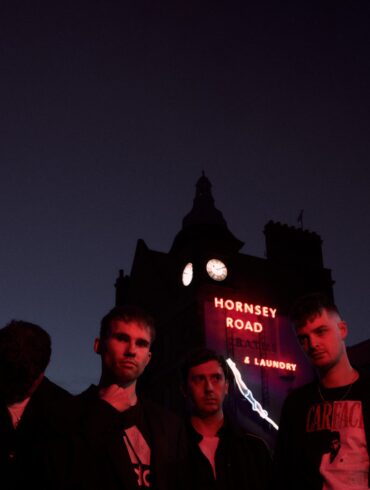 The four members of the band The Clockworks photographed in the dark