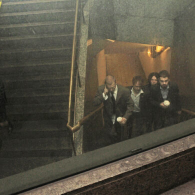 The four members of the band Lip Critic walking up the stairs